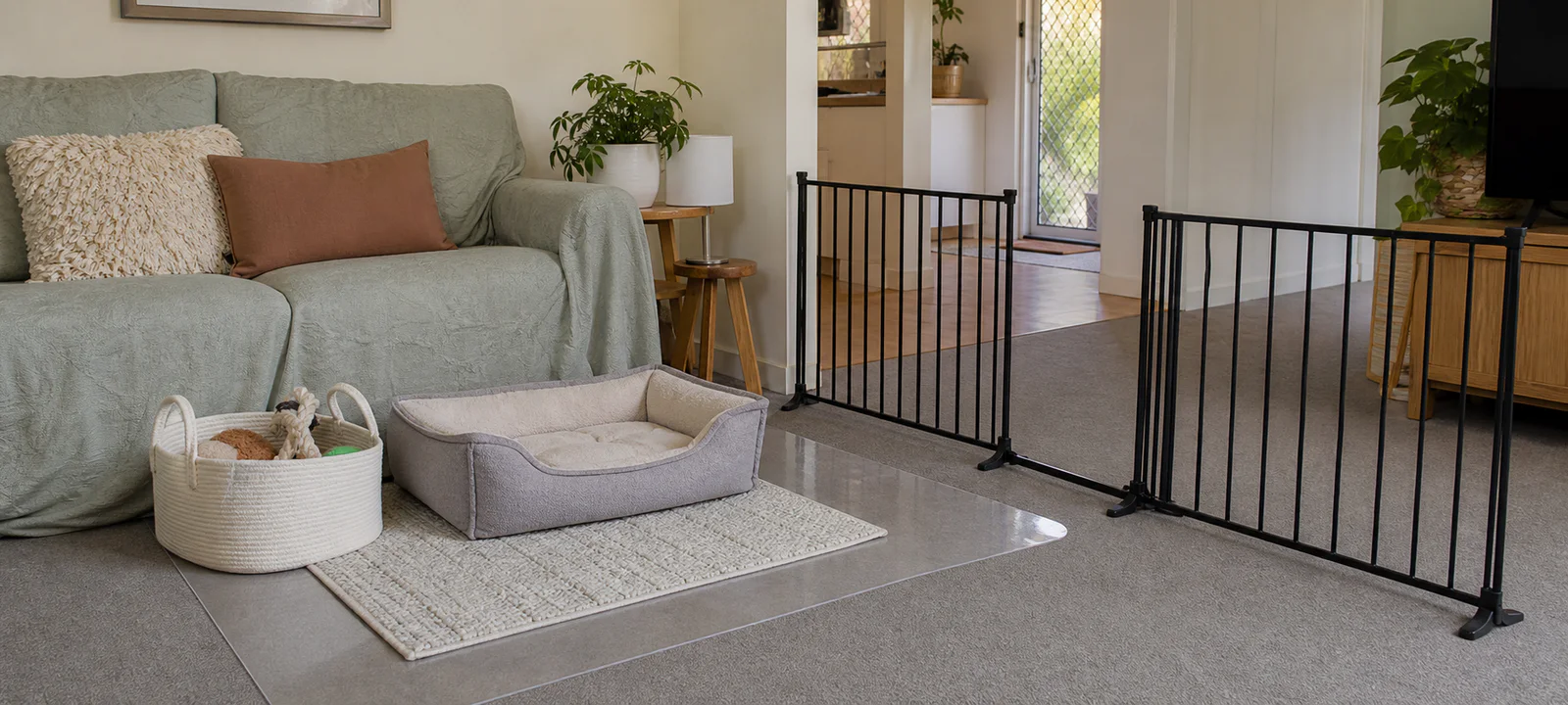 A rental-friendly pet zone with removable floor protection, a washable sofa cover, freestanding barrier and portable storage
